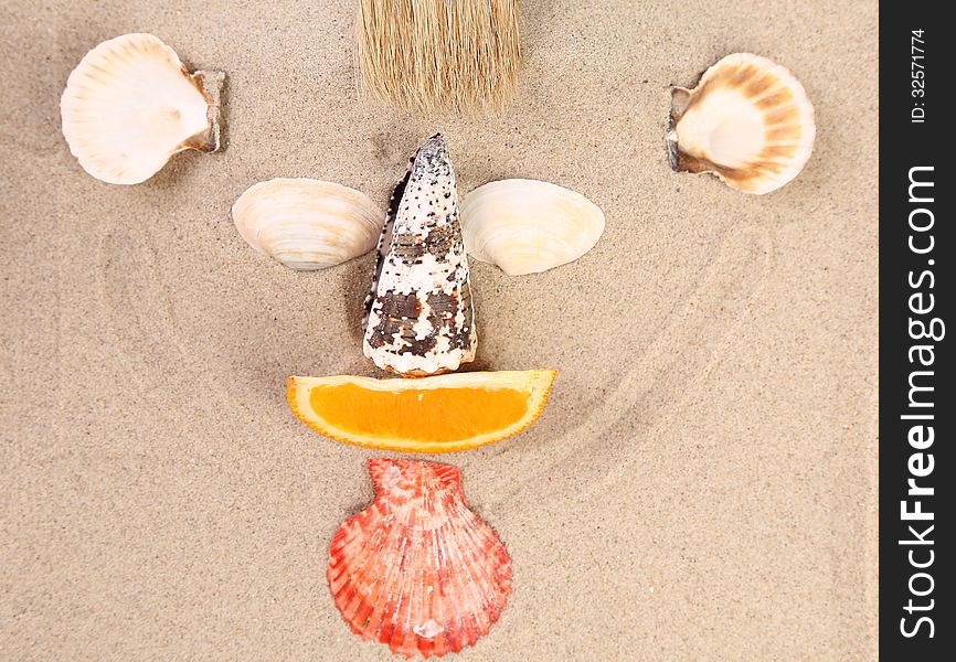 Mug made ??of shells, brush and orange slices on the sand. Mug made ??of shells, brush and orange slices on the sand