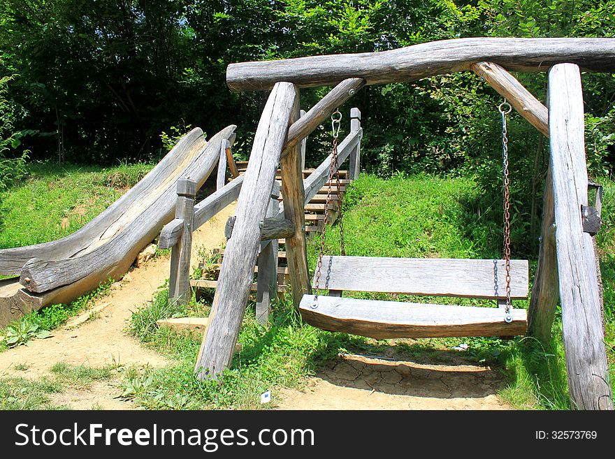 Wooden swing and slide for play and relaxation. Wooden swing and slide for play and relaxation