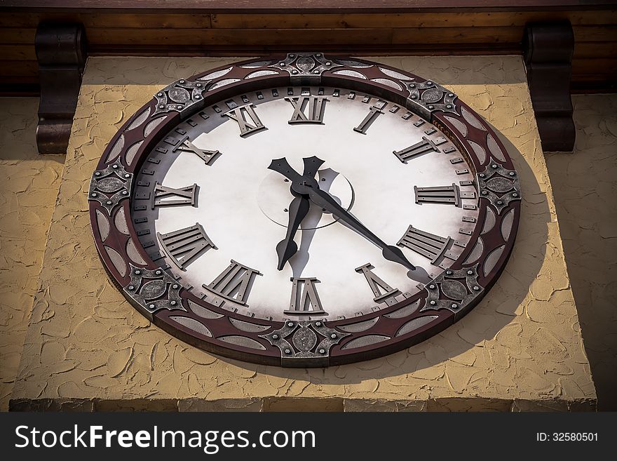 Old vintage style clock on textured yellow wall. Old vintage style clock on textured yellow wall