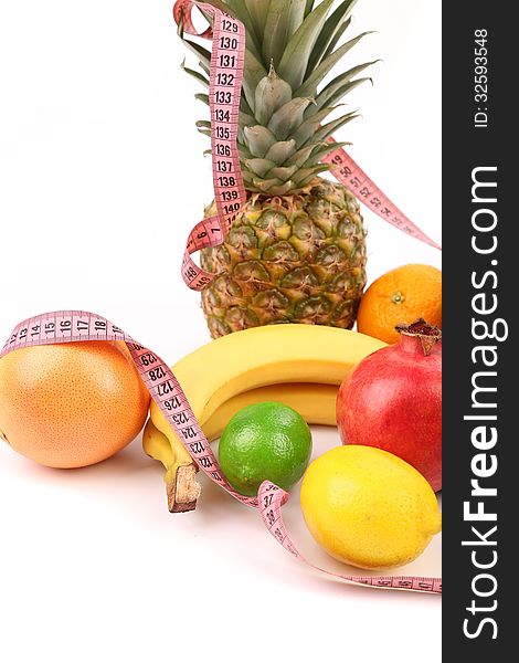Tape measure and fruits composition isolated on a white background