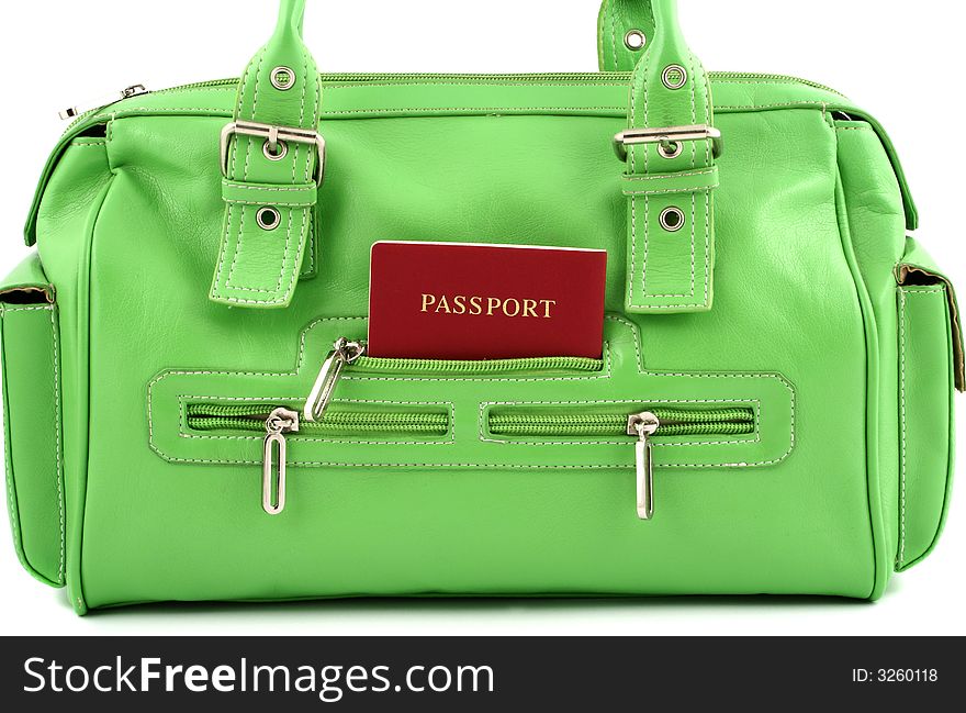 Front view at green handbag with passport in one of pocket. Front view at green handbag with passport in one of pocket