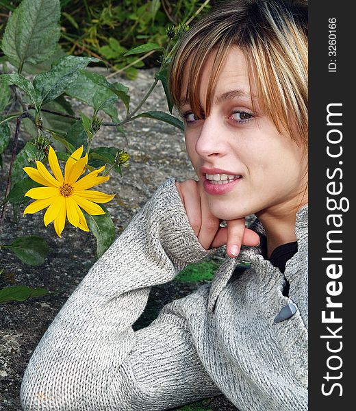 Girl in nature with yellow flower. Girl in nature with yellow flower