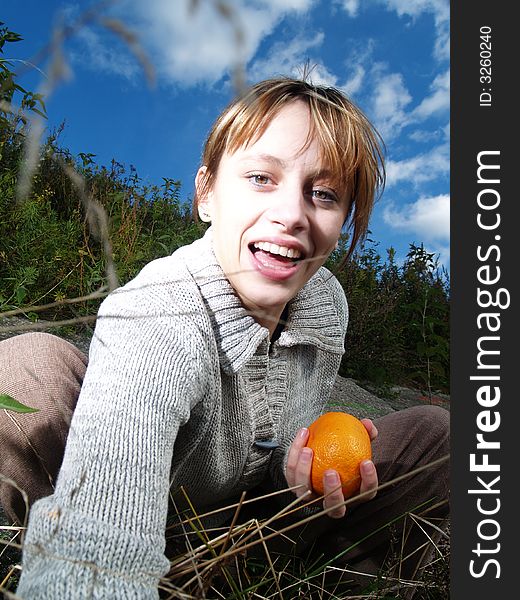 Girl in nature with orange. Girl in nature with orange