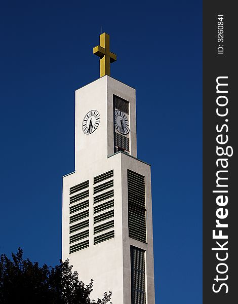 White tower of modern church, blue sky