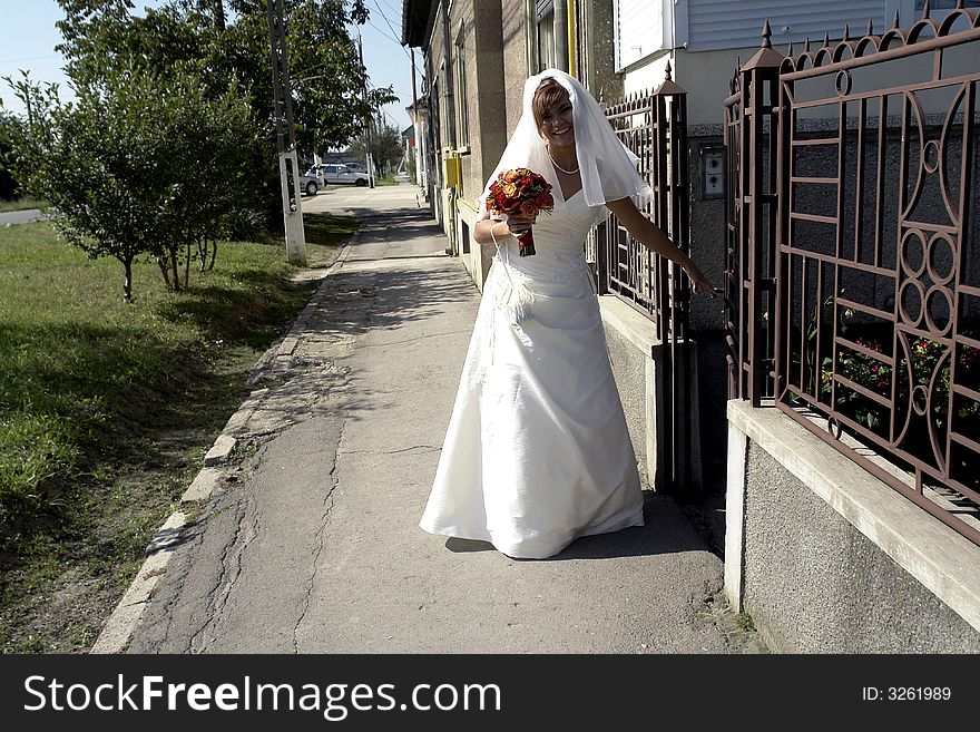 Bride smiling living her home before wedding