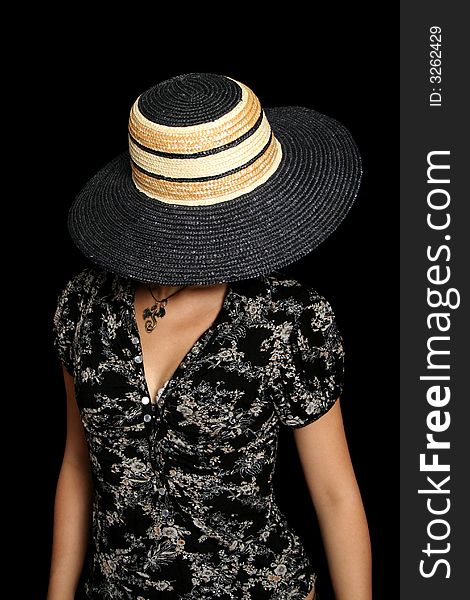 The young girl in a hat, on a black background. The young girl in a hat, on a black background