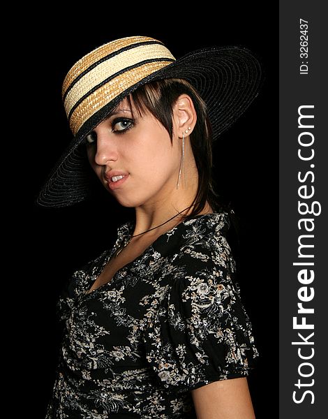 The young girl in a hat, on a black background. The young girl in a hat, on a black background