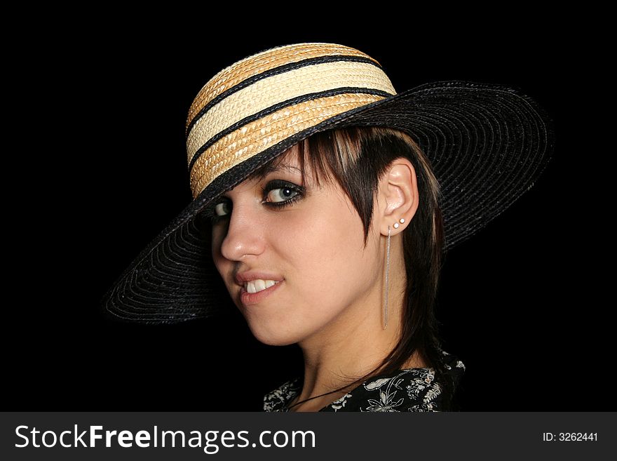 The young smiling girl in a straw hat, on a black background. The young smiling girl in a straw hat, on a black background