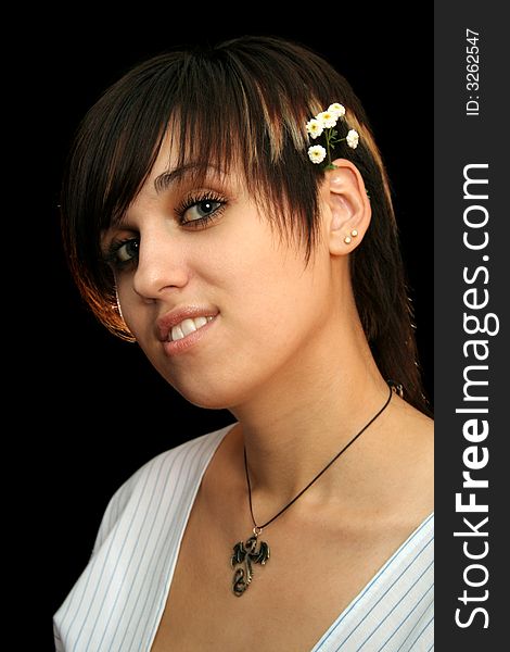 The young beautiful girl with flowers, isolated on a black background