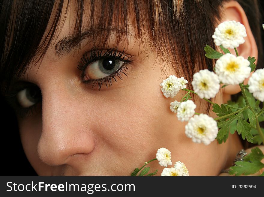 The young beautiful girl with flowers, isolated on a black background. The young beautiful girl with flowers, isolated on a black background