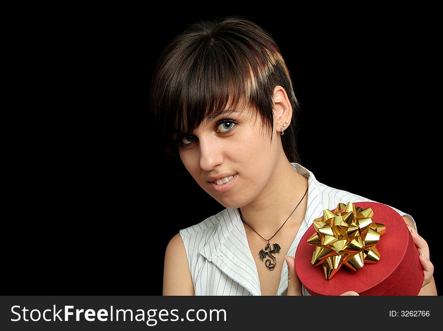 The young girl holds a box with a gift, isolated on black background. The young girl holds a box with a gift, isolated on black background