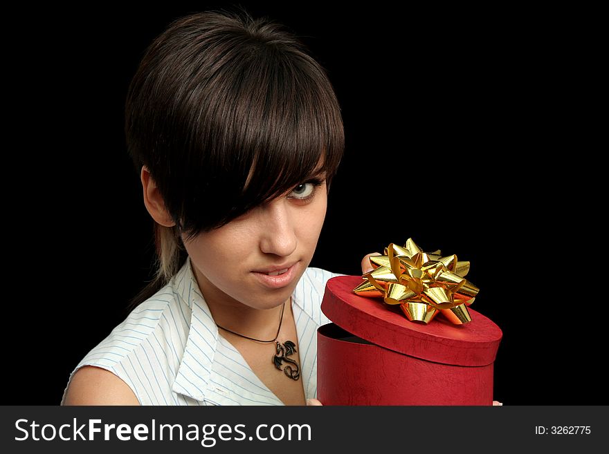 The young girl holds a box with a gift, isolated on black background. The young girl holds a box with a gift, isolated on black background