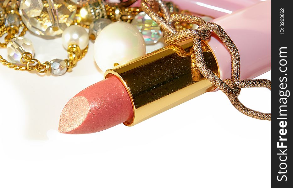 pink lipstick and beads closeup. pink lipstick and beads closeup