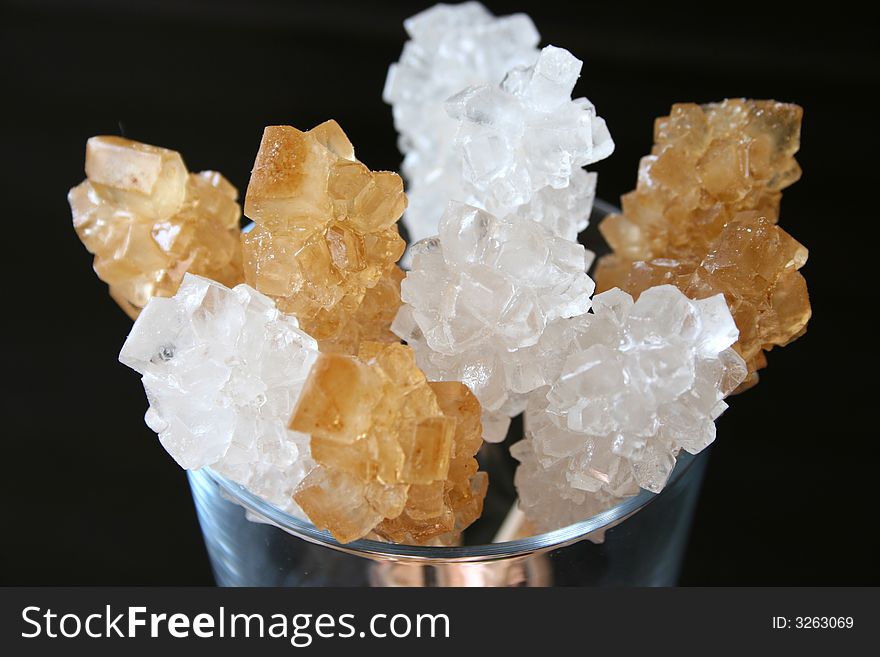 Caramel and white sugar crystals in a glass mug