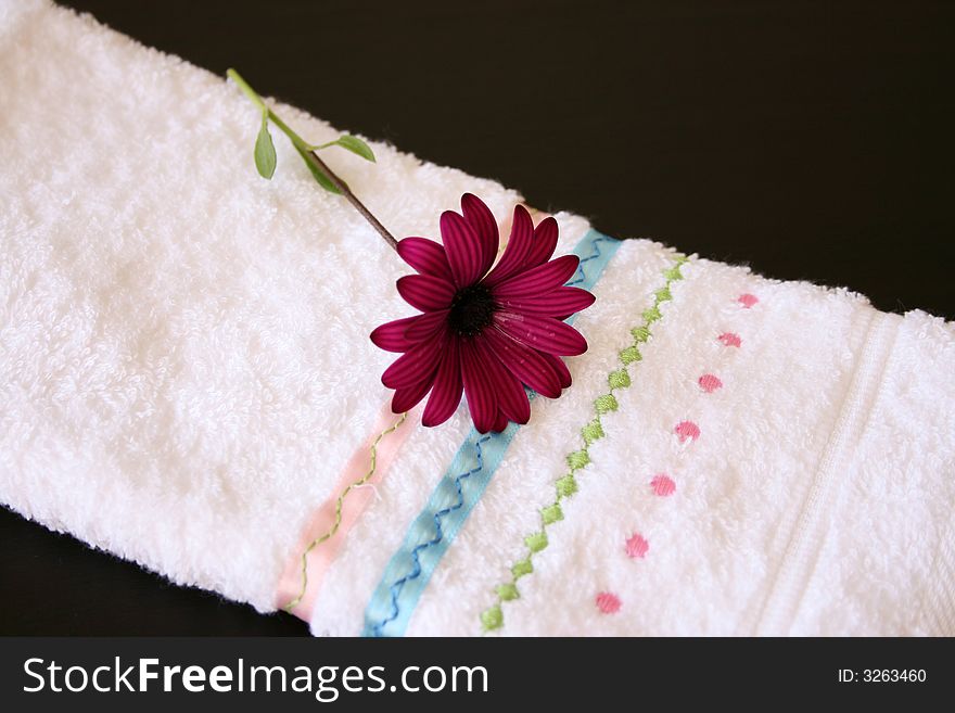 Single Purple Daisy flower on a hand towel. Single Purple Daisy flower on a hand towel