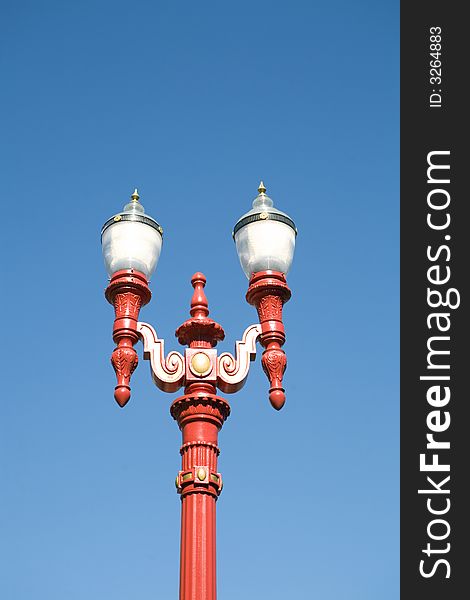 Red Gas Lamp Light against a blue sky