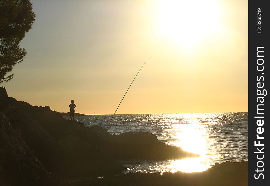 Fishing episode in a beautiful sunset in the adriatic sea.