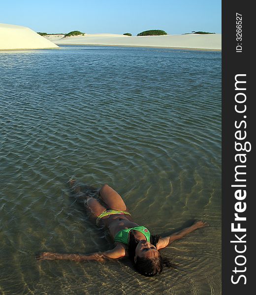 Girl in the lagoon between dunes - National Park of the Lencois Maranhenses - Brazil. Girl in the lagoon between dunes - National Park of the Lencois Maranhenses - Brazil