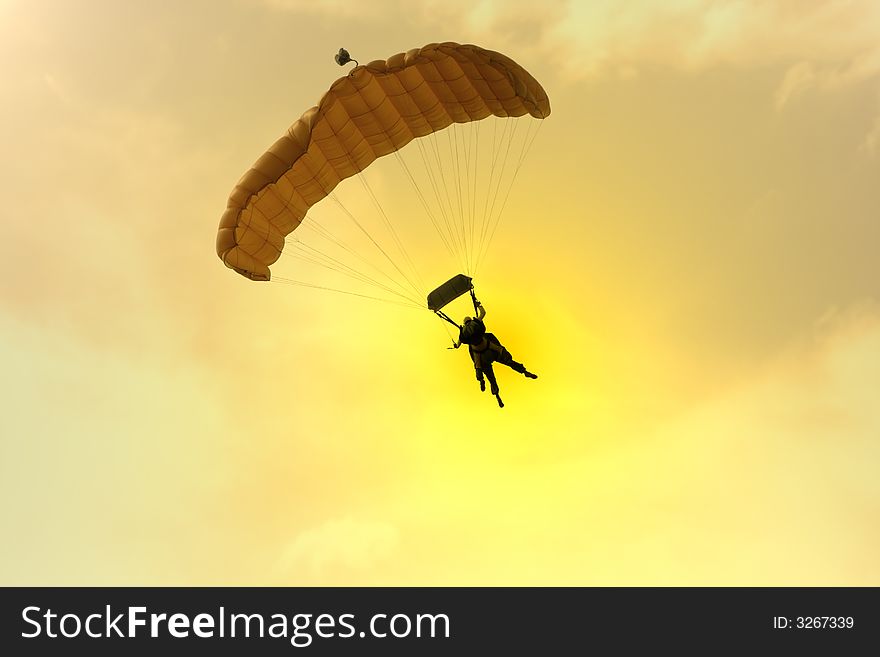 Two Parachuter's silhouettes at sunset