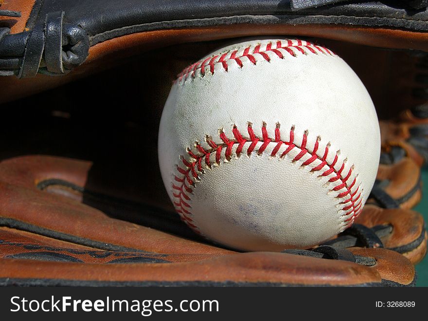 Baseball in the webb of glove. Baseball in the webb of glove