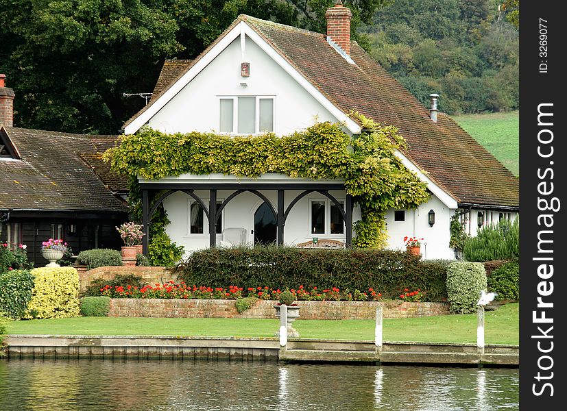 Riverside House on the Banks of the River Thames in England in early Autumn. Riverside House on the Banks of the River Thames in England in early Autumn