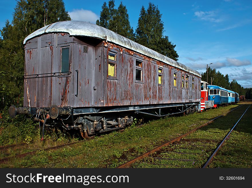 Old trains in abandoned rail yard in summer evening. Old trains in abandoned rail yard in summer evening