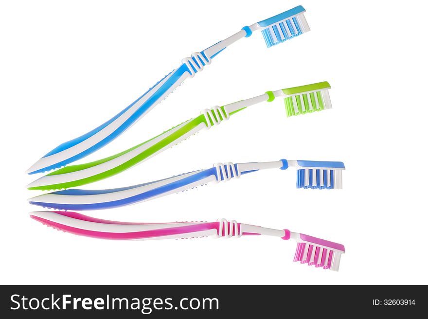 Four new multi-colored toothbrushes are on a white background