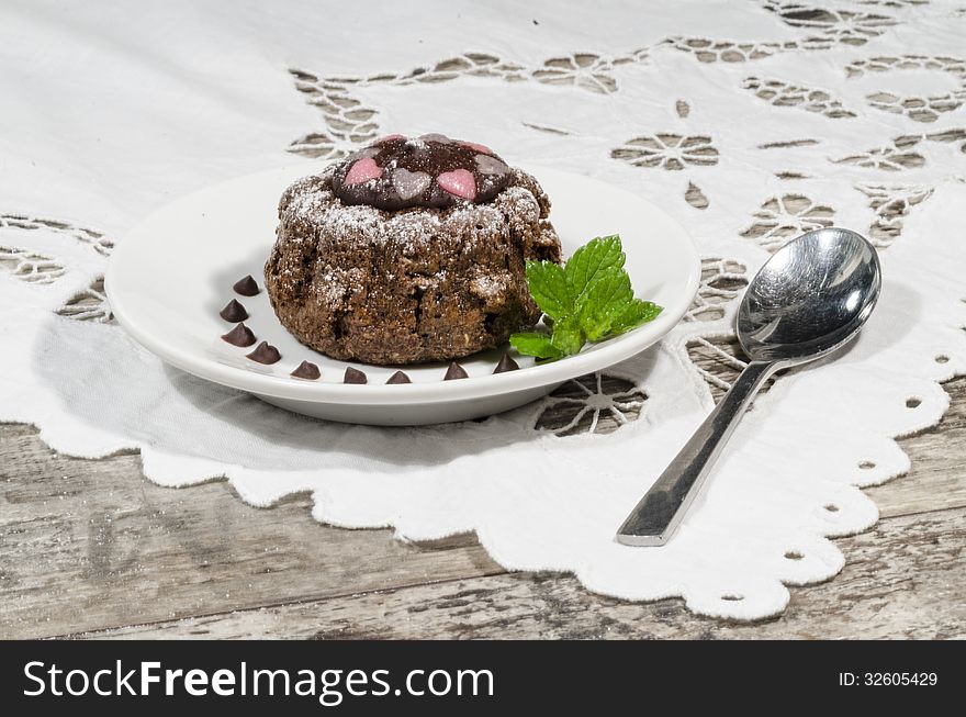 Diet chocolate cupcakes on yeliow plate mint leaf