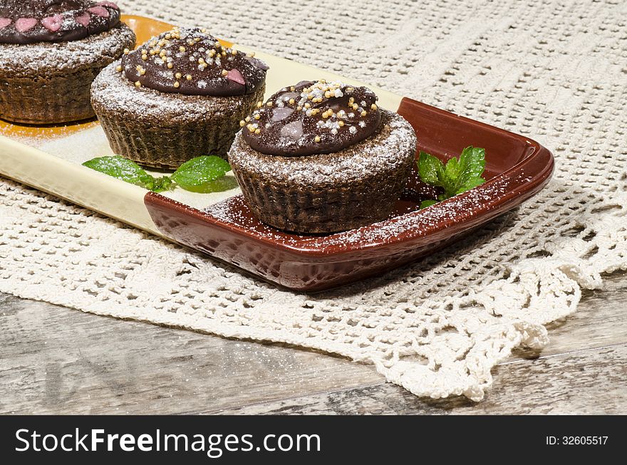 Diet chocolate cupcakes on yeliow rectangular plate