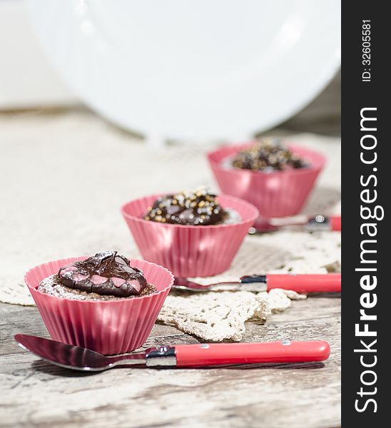 Diet chocolate cupcakes and three spoons. Vertical format