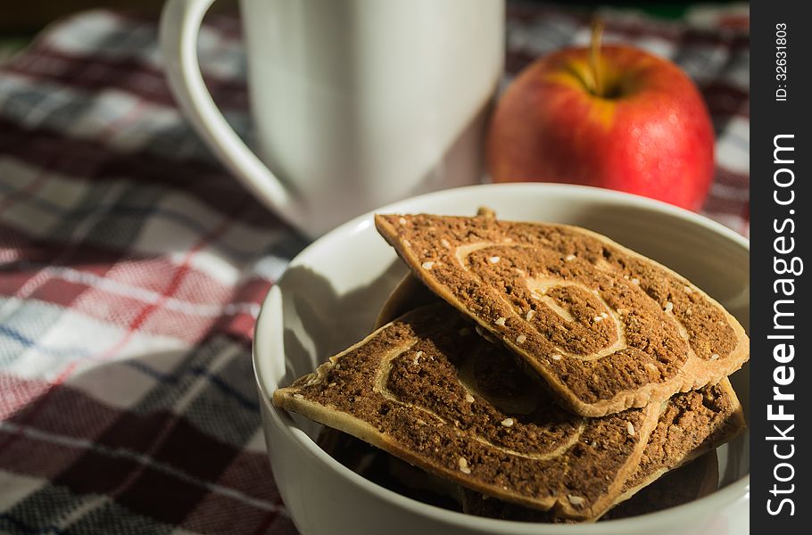 Cookies, apple and cup of coffee on the cloth. Cookies, apple and cup of coffee on the cloth