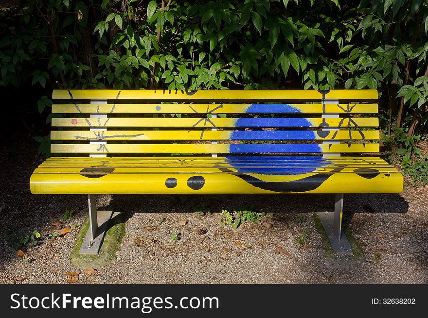 Artistically painted yellow bench in a park. Artistically painted yellow bench in a park