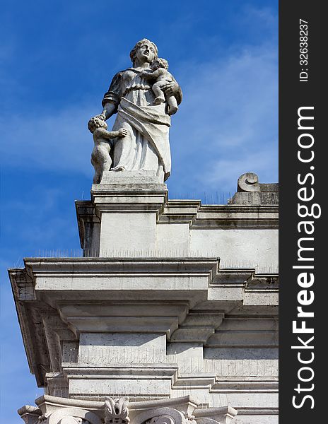 Statue At The Top Of A Neoclassic Building