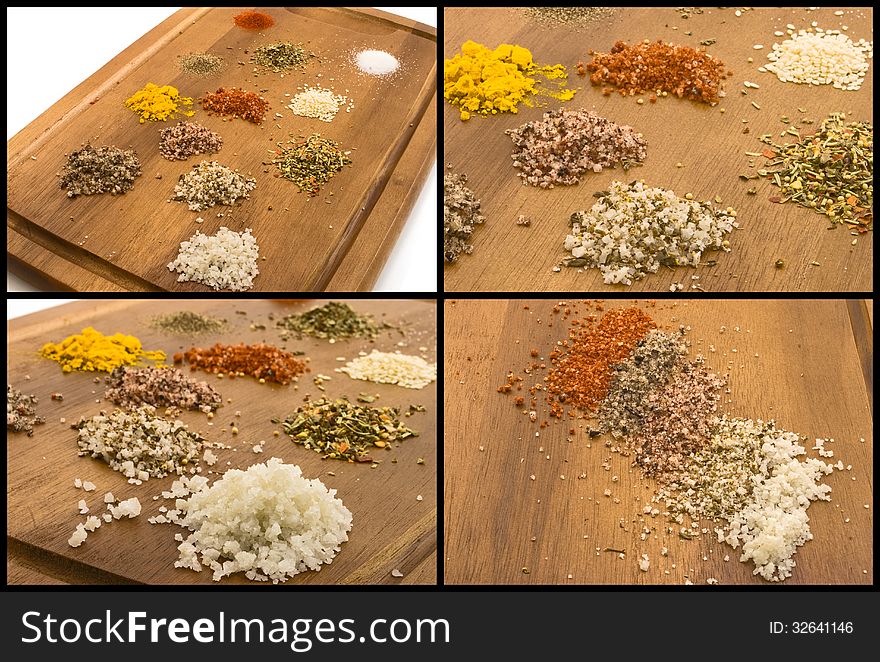 A variety of salts and herbs on a wooden board. A variety of salts and herbs on a wooden board.