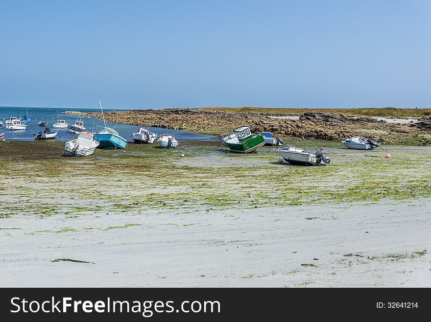 Boats laying on dry land as a result of low tide