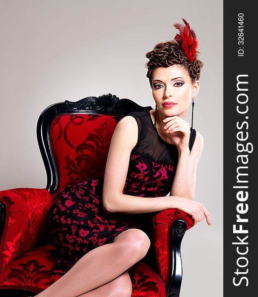 Woman With Fashion Hairstyle And Red Armchair