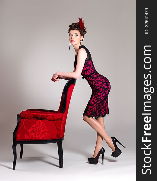 Woman with fashion hairstyle and red armchair