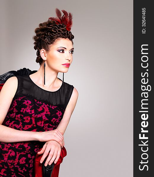 Woman With Fashion Hairstyle And Red Armchair