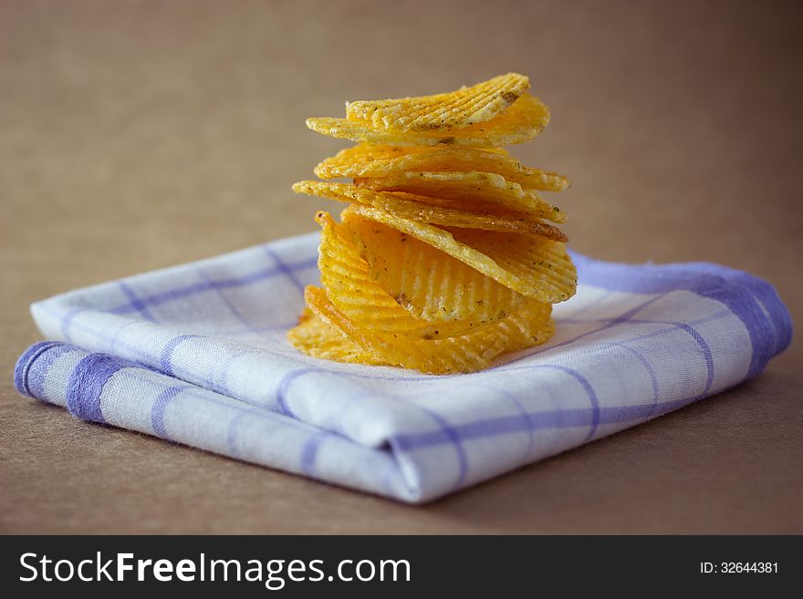 Potato chips on brown background
