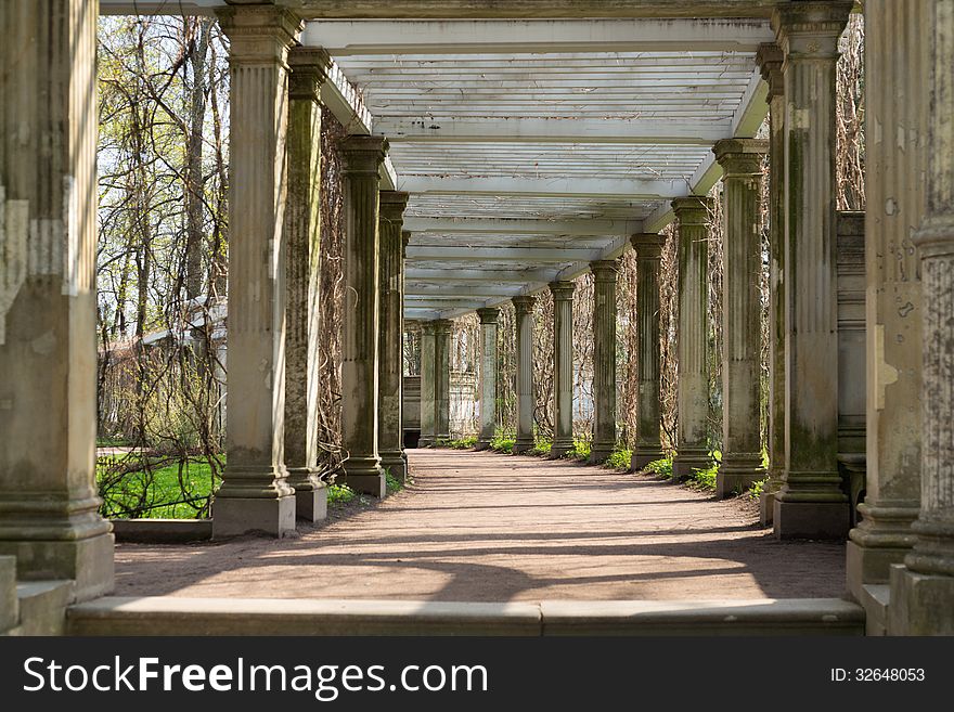 Ancient columns corridor in spring grass. St. Petersburg, Russia, Catherine Park. Ancient columns corridor in spring grass. St. Petersburg, Russia, Catherine Park