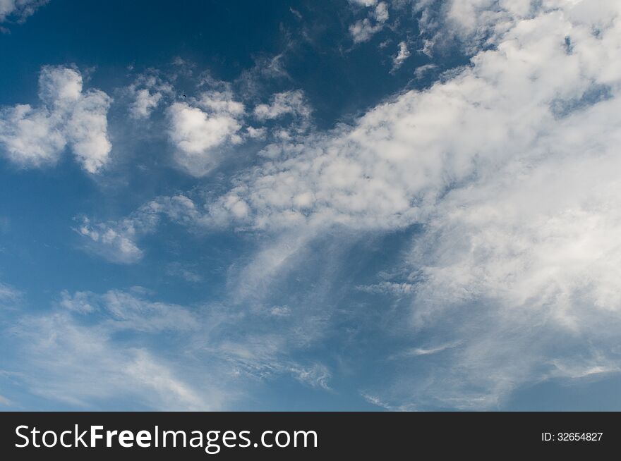 White fluffy clouds in the blue sky. White fluffy clouds in the blue sky