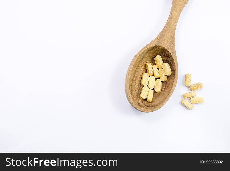 Vitamin B complex on wooden spoon