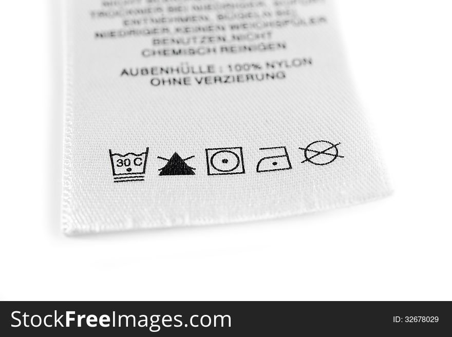 Close up view on an isolated washing label tag. Close up view on an isolated washing label tag.