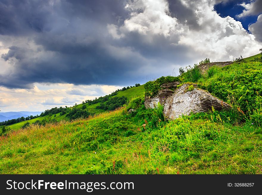 Boulders on a mountain top under a large cloud. Boulders on a mountain top under a large cloud