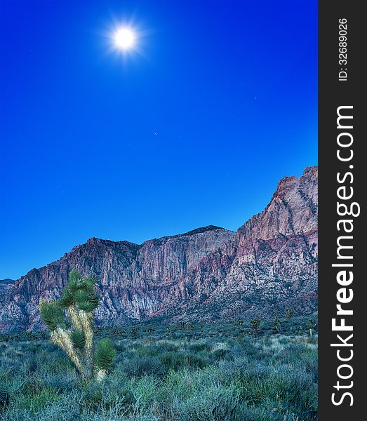 Desert With Red Rock Mountains Early In The Morning With A Brigh