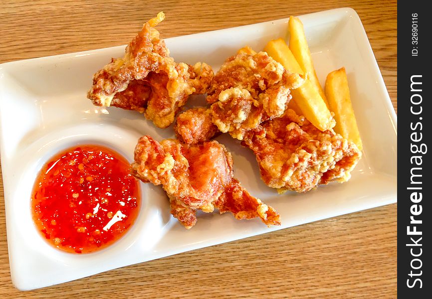 Deep fried chicken and french fried serve with chilli-sweet dipping