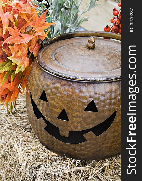 A still-life of halloween, autumn decorations - leaves, straw, pumpkin; jack-o-lantern. A still-life of halloween, autumn decorations - leaves, straw, pumpkin; jack-o-lantern
