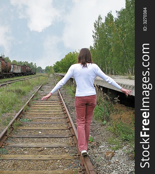 Girl goes on rail old railroad. 2007