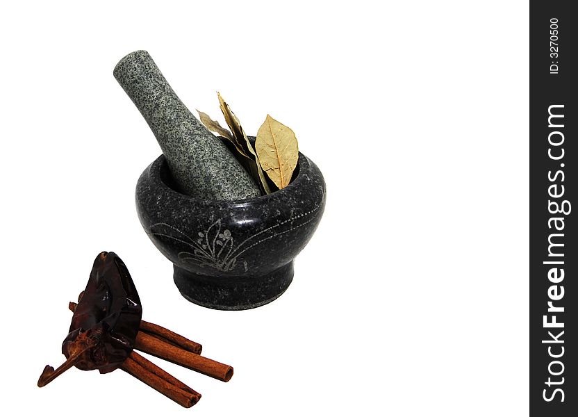 Bay leaves nestled in a stone mortar and pestle set. Bay leaves nestled in a stone mortar and pestle set.
