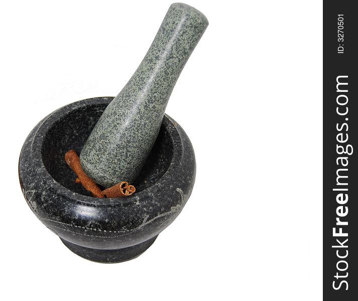 Sticks of cinnamon are being ground by mortar and pestle. Sticks of cinnamon are being ground by mortar and pestle.
